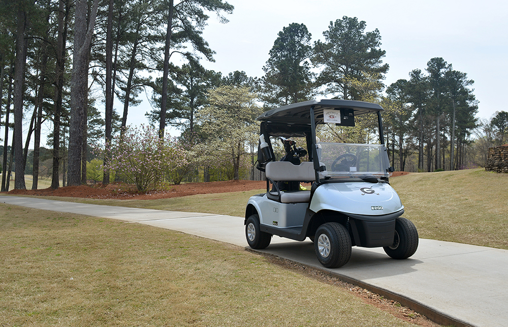 Photo of a golf cart on a path at the UGA Golf Course.