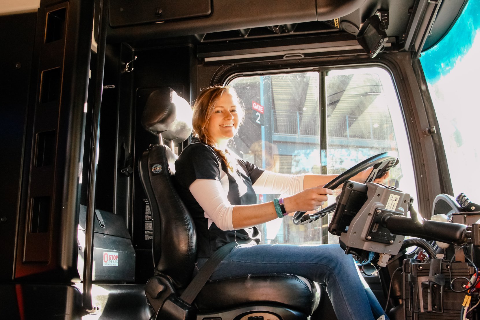 Photo of a bus driver in the driver's seat. 