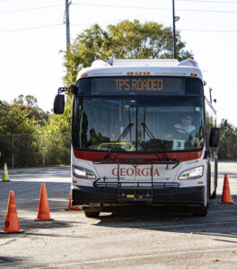 Traffic cones and bus with TPS ROADeo sign
