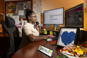 Kimbree Woods Wallace, customer relations specialist for Transportation and Parking Services, works at her desk in Joe Frank Harris Commons.