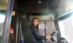 Student bus driver smiling in bus