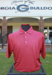 Men's golf shirt with University of Georgia logo on it shown outside with the UGA golf course in the background
